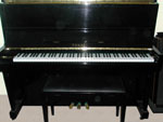 Full-on shot of piano and bench.